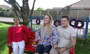 Family of Postie Jay sat on a bench