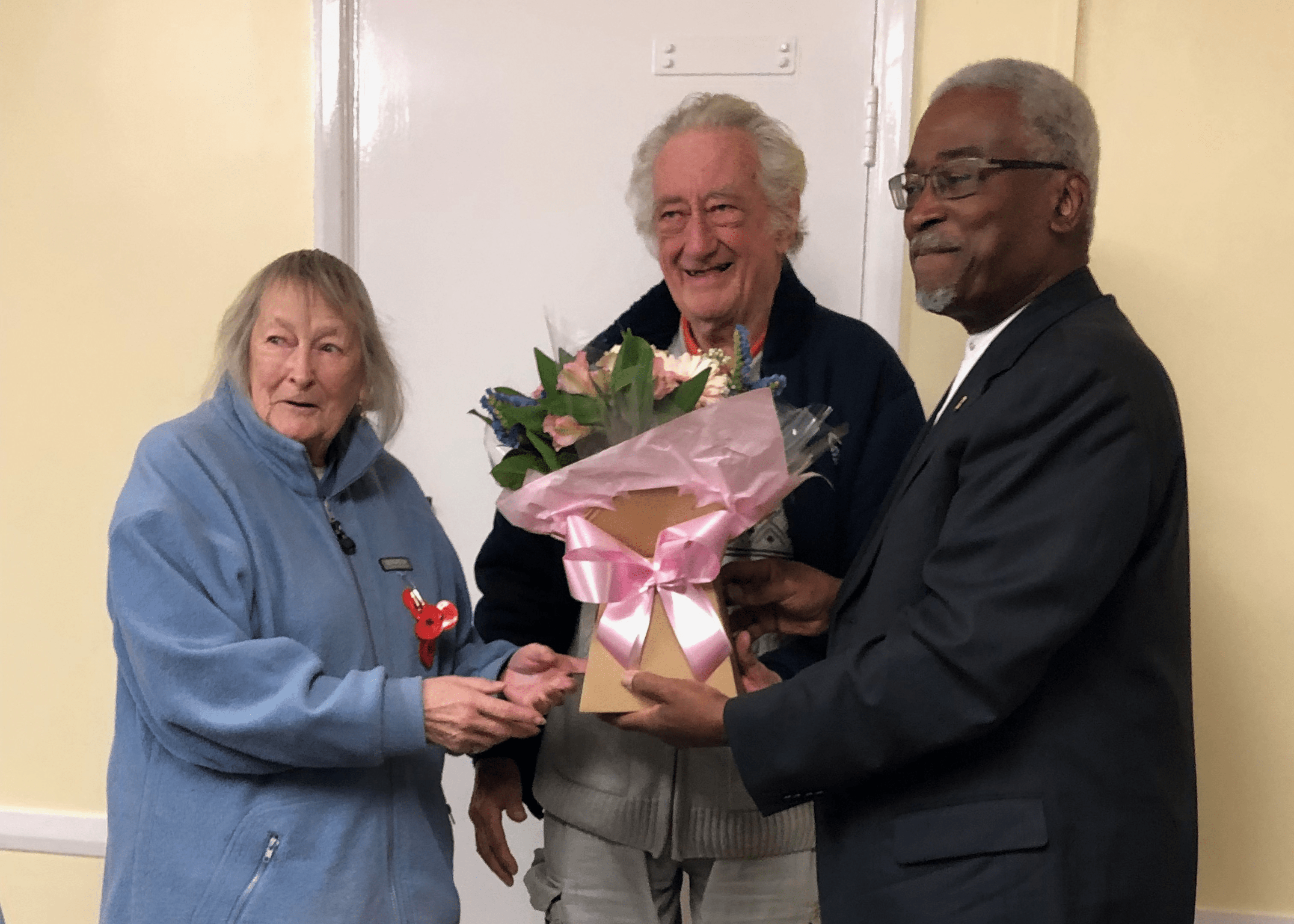 Man and woman receiving a bouquet of flowers